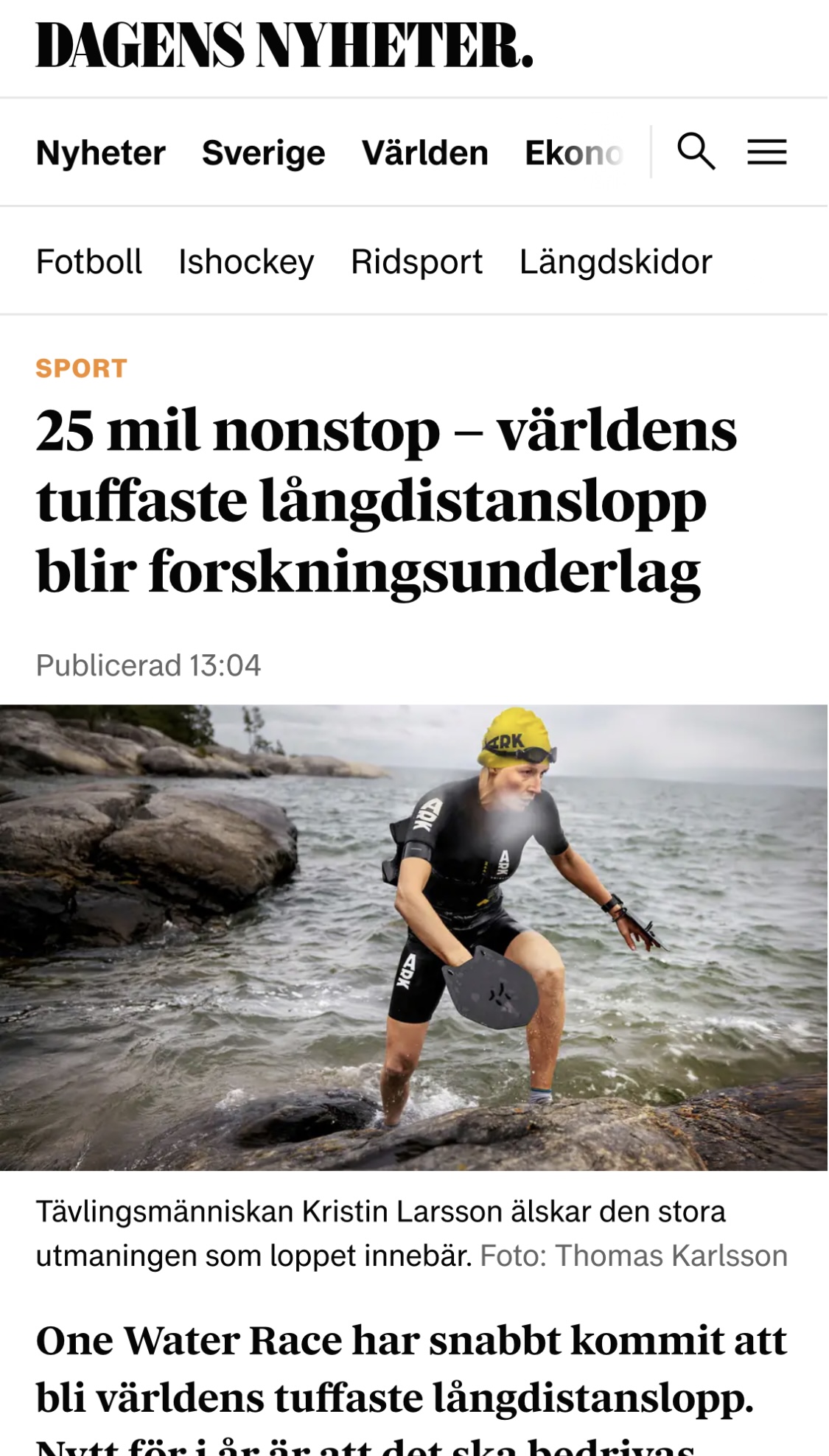 Kristin Larsson climbing out of the water onto rocks during a swimrun race