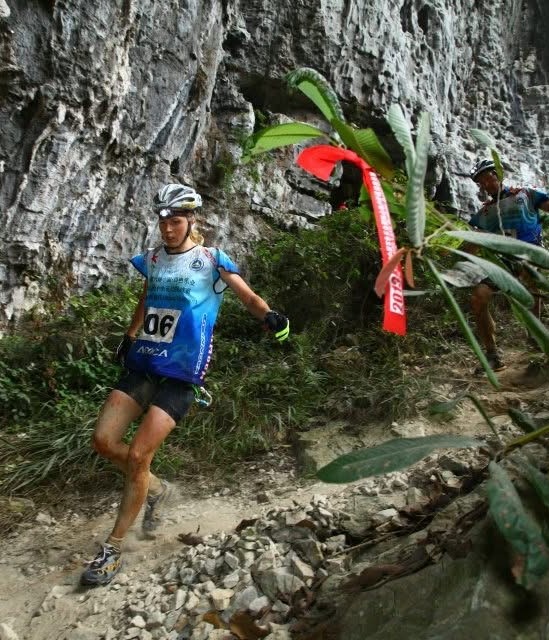 KRISTIN LARsson trail running on a rocky mountain path